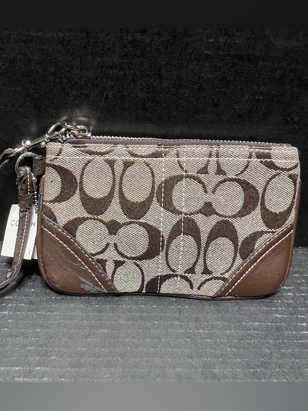 Coach signature wristlet brown on tan with hang tag good Condition is NWT